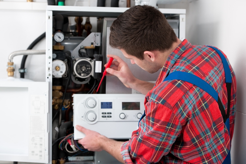 Gas Safe engineer working on a boiler in Thames Ditton